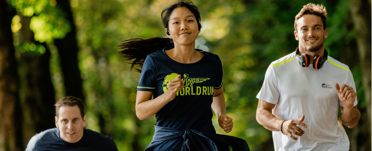 Džiaugsmingai bėgantys trys &bdquo;Wings for Life World Run&ldquo; bėgimo dalyviai dėvi &bdquo;Philips&ldquo; sportines ausines.
